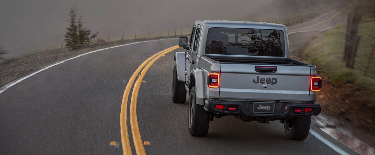 The 2021 Jeep Gladiator Rubicon being driven on a winding road.