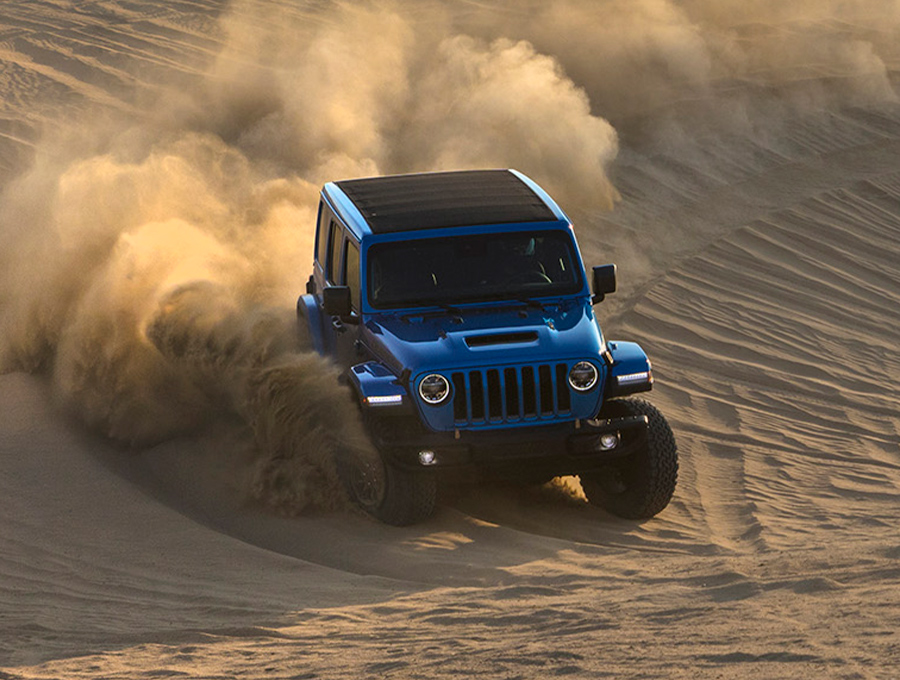 The 2021 Jeep Wrangler Rubicon 392 being driven down a sand dune.