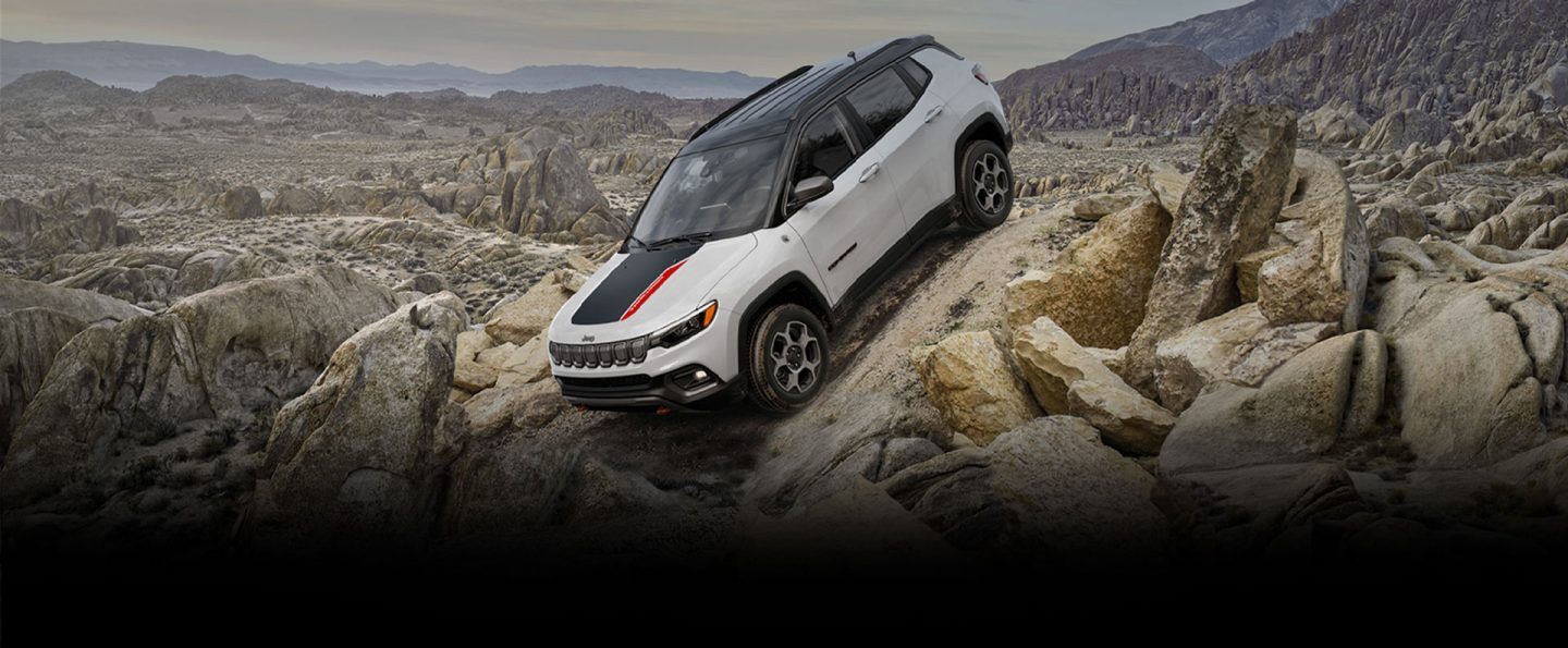The 2022 Jeep Compass Trailhawk descending a steep, rocky slope.