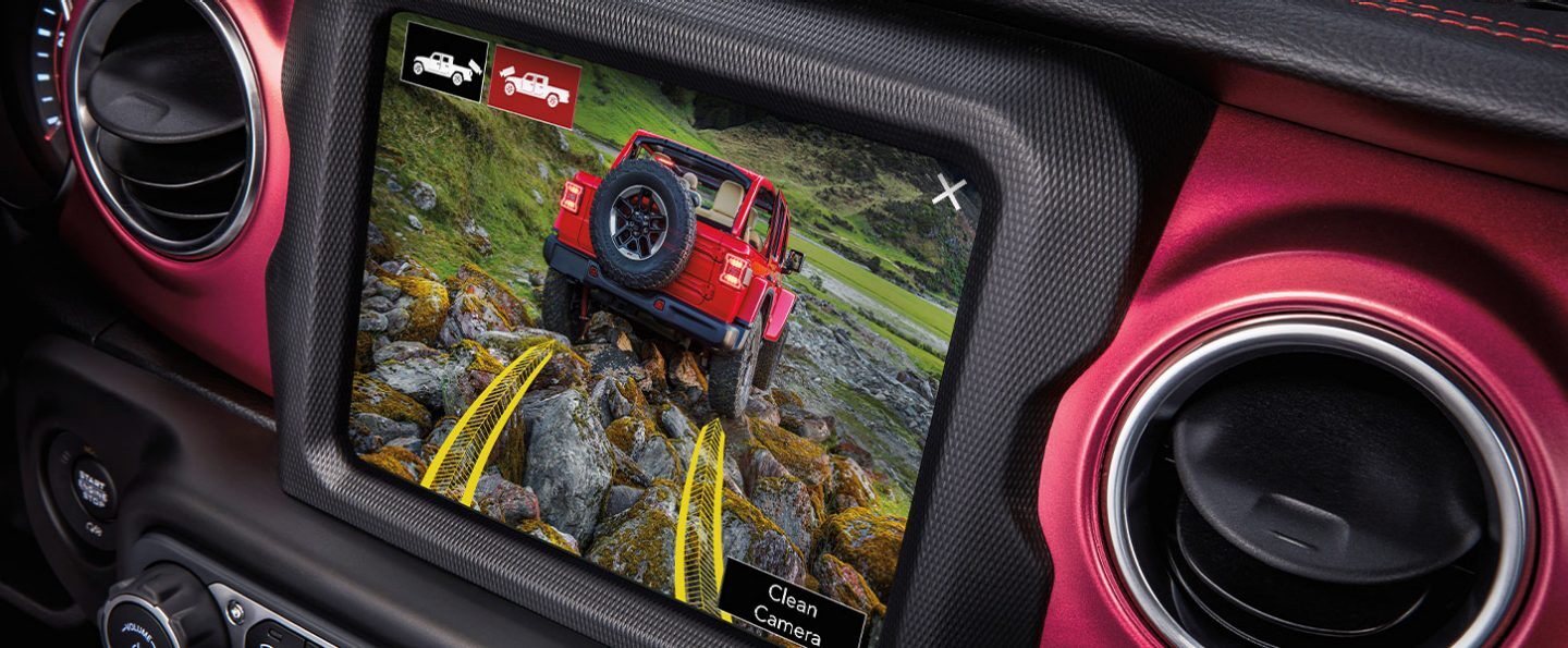The touchscreen in the 2022 Jeep Gladiator displaying the area ahead with a projected path overlaid on the image.